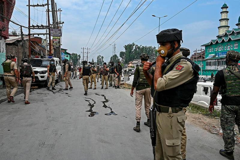 Security personnel gather near the site where suspected militants fired at police near Nowgam bypass in Srinagar.  AFP