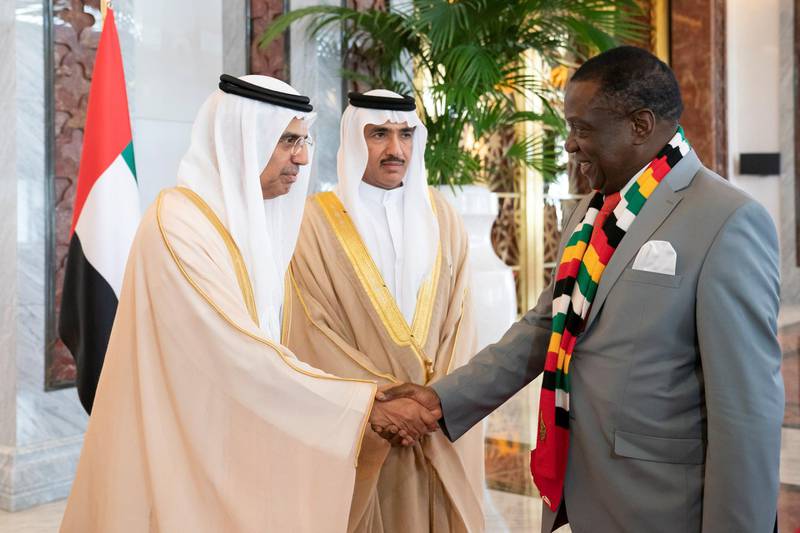 ABU DHABI, UNITED ARAB EMIRATES - March 16, 2019:  HE Obaid Humaid Al Tayer, UAE Minister of State for Financial Affairs (L) greets HE Emmerson Mnangagwa, President of Zimbabwe (R), during a reception at the Presidential Airport. 

( Ryan Carter for the Ministry of Presidential Affairs )
---