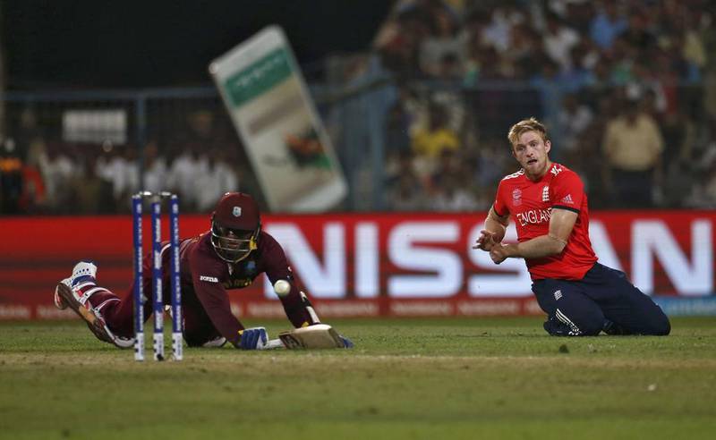 West Indies Marlon Samuels dives successfully to make his crease as England’s David Willey throws the ball. Reuters