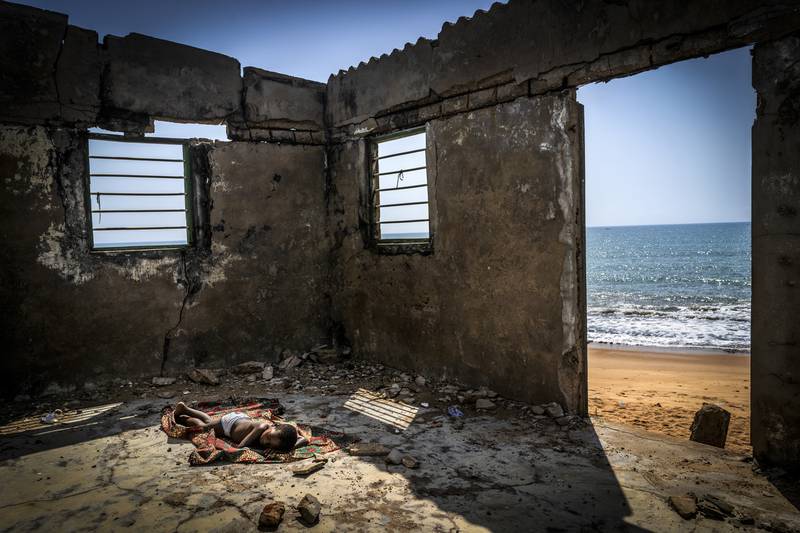 The winner of the Environmental Photographer of the Year Award is 'The Rising Tide Son', by Antonio Aragon Renuncio, which shows a child sleeping on the floor of his house that is about to collapse, destroyed by coastal erosion on Afidegnigba beach in Ghana. Photo: Antonio Aragon Renuncio / Environmental Photographer of the Year 2021