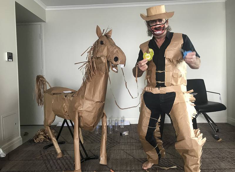 David Marriott poses with his paper horse in his hotel room in Brisbane, Australia, April 1, 2021. While in quarantine inside his Brisbane hotel room, art director Russell Brown was bored and started making a cowboy outfit from the paper bags his meals were being delivered in. His project expanded to include a horse and a clingfilm villain that he has daily adventures with, in images that have gained a huge online following. (David Marriott via AP)