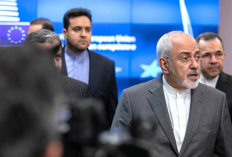 Iranian Foreign Minister Javad Zarif, second right, speaks with the media after a meeting with European Union foreign policy chief Federica Mogherini at the Europa building in Brussels on Tuesday, May 15, 2018. (AP Photo/Olivier Matthys)