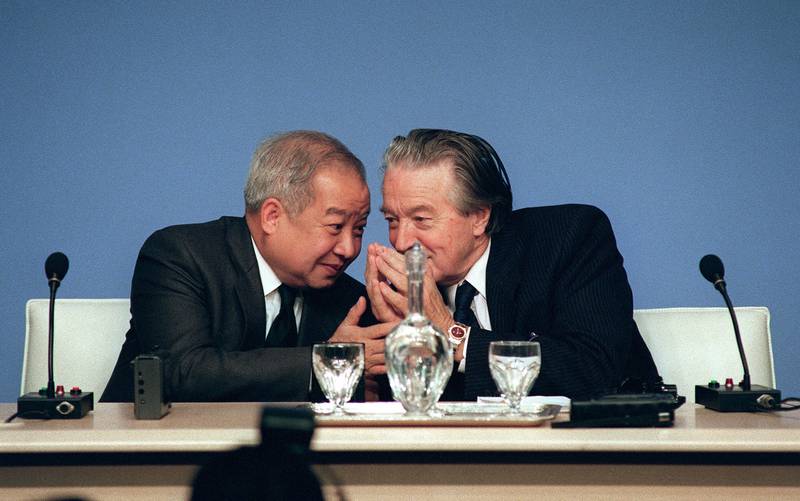 Cambodia's Prince Norodom Sihanouk, left, talks to France's then foreign affairs minister Roland Dumas during the Cambodian Peace Conference in Paris. AFP