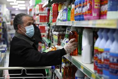 A shopper wears a mask at a supermarket in Amman. Reuters