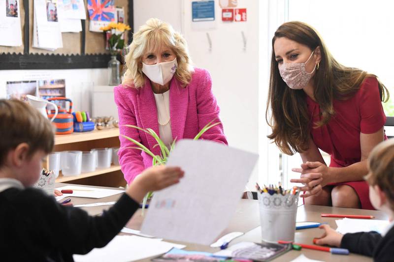 Catherine, Duchess of Cambridge and Jill Biden view a child's work during their visit. AFP