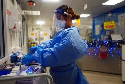 A nurse in full PPE on a ward for Covid patients at King's College Hospital, in south-east London, in December 2021. PA