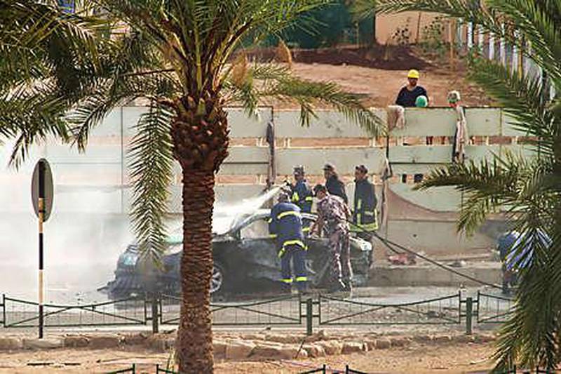 Jordanian police put out a fire after a Grad-type rocket smashed into a street in Aqaba killing a taxi driver.