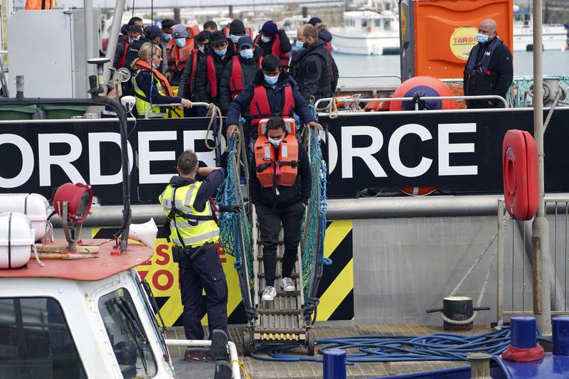 A group of people thought to be migrants are brought in to Dover, Kent, following a small boat incident in the Channel. PA