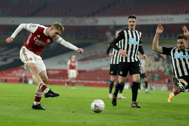Arsenal's Emile Smith Rowe, left, scores the opening goal during the English FA Cup third round soccer match between Arsenal and Newcastle United at the Emirates Stadium in London, England, Saturday, Jan. 9, 2020. (AP Photo/Matt Dunham)