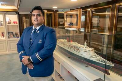 Brendan Clarke with a model of the QE2 aboard the floating hotel in Port Rashid, Dubai. All photos: Antonie Robertson / The National
