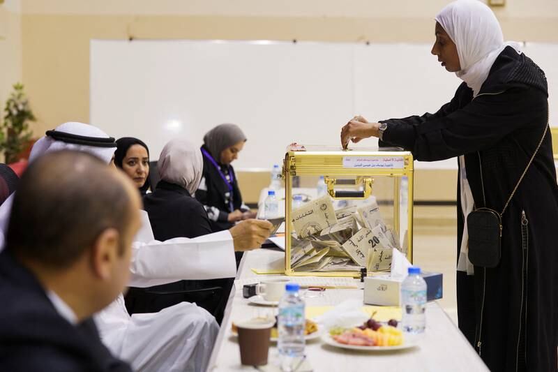 A woman votes during parliamentary elections at a polling station in Kuwait City. Reuters