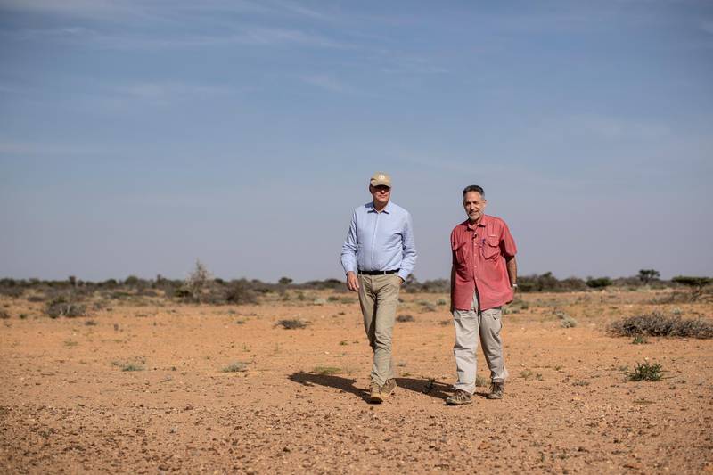 Dominique Burgeon, center, Director of the Emergency and Resilience Division of the Food and Agriculture Organization and Keith Cressman, right, Senior Locust Forecasting Officer, walk in the desert in the semi-autonomous Puntland region of Somalia. AP
