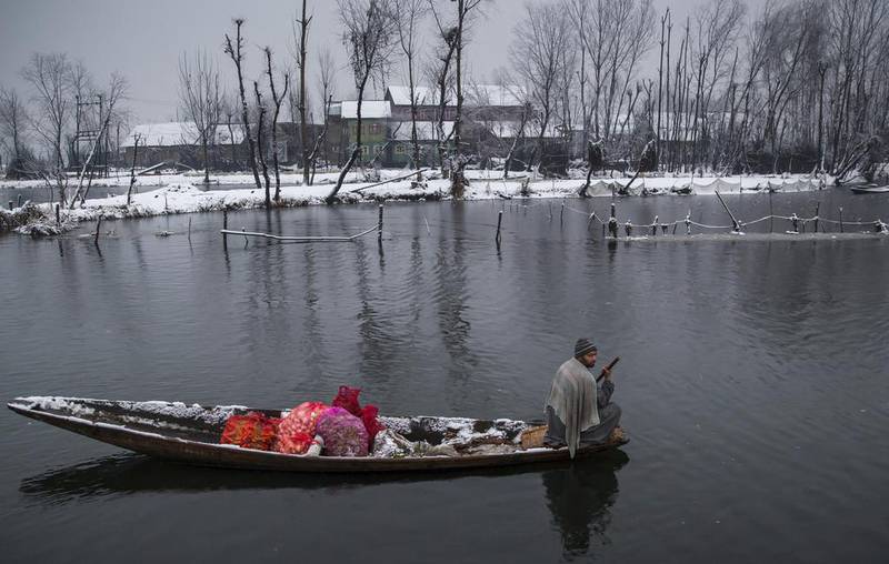 A man rows his boat heading towards the floating vegetable market on Dal Lake in Srinagar, Indian controlled Kashmir. Dar Yasin / AP Photo