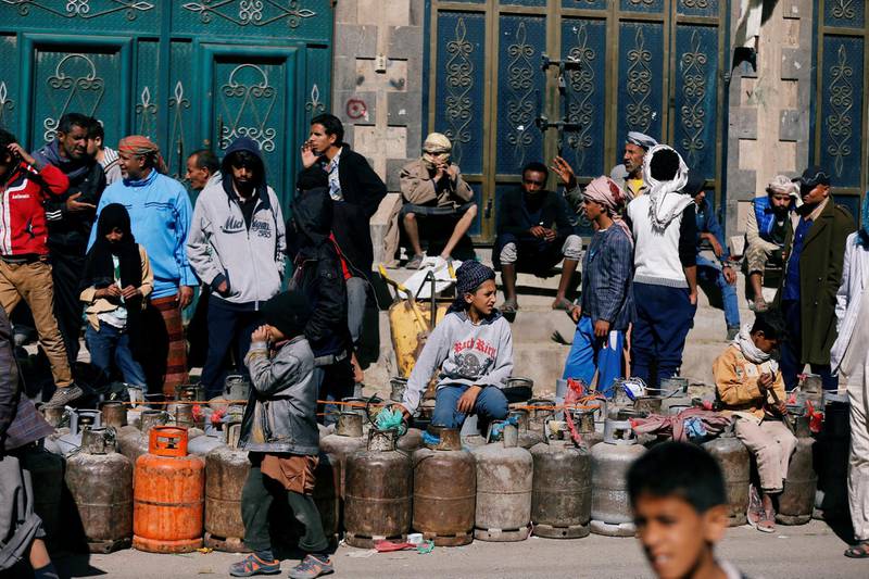People wait to fill their cooking gas cylinders outside a gas filling station amid a scarcity in cooking gas supplies in Sanaa, Yemen. Khaled Abdullah / Reuters