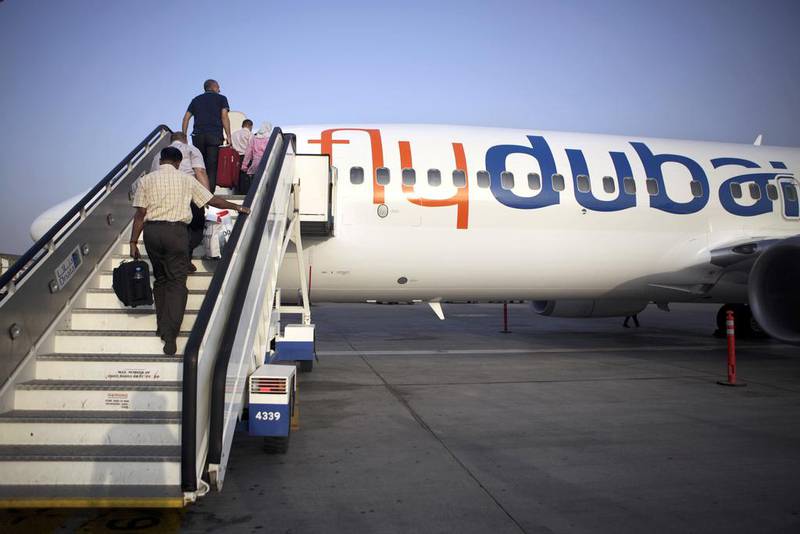 Passengers board a flydubai flight. Low-cost airlines offer an alternative for UAE travellers.  Galen Clarke / The National