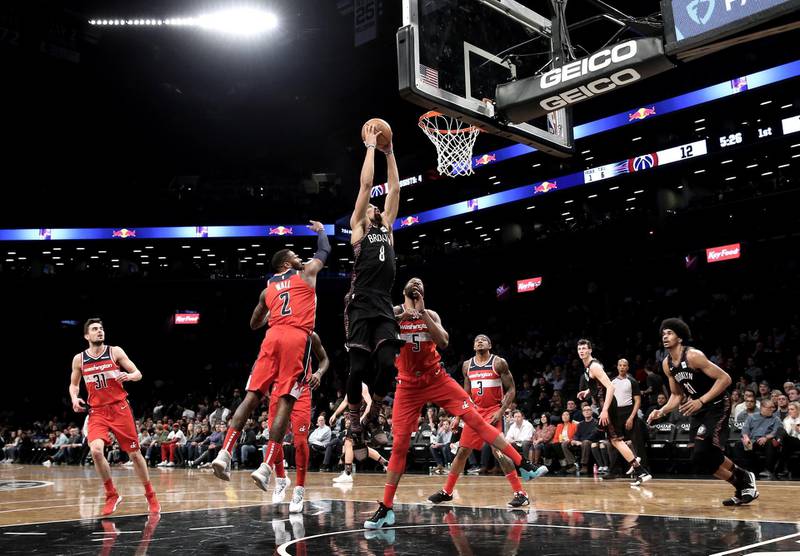 Brooklyn Nets guard Spencer Dinwiddie shoots over two Washington Wizards defenders in the first half of an NBA match in Brooklyn, New York. EPA