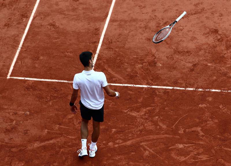 Novak Djokovic throws his racquet as he plays against Dominic Thiem during their quarter final match at the the French Open in 2017. EPA