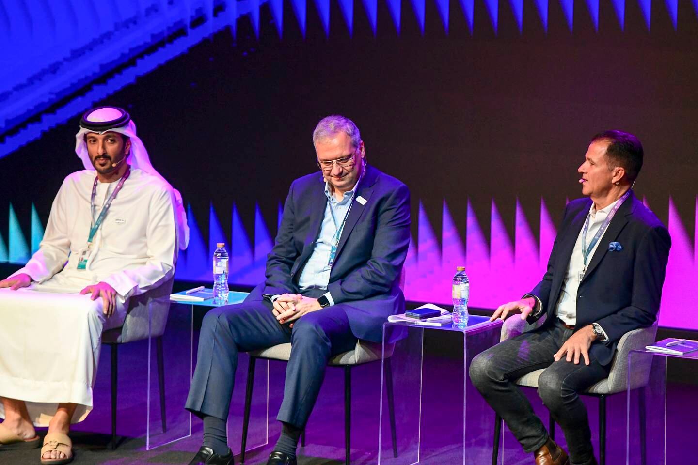 From left, Abdulla bin Touq, UAE Minister of Economy, Bashar Kilani, managing director of Accenture, and Mark Zaleski, managing director and partner at BCG Digital Ventures, during a panel discussion at the Dubai Metaverse Assembly on Wednesday. Khushnum Bhandari / The National