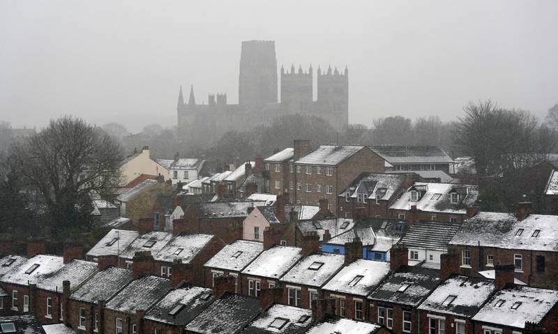 Snow covers the rooftops of Durham. PA