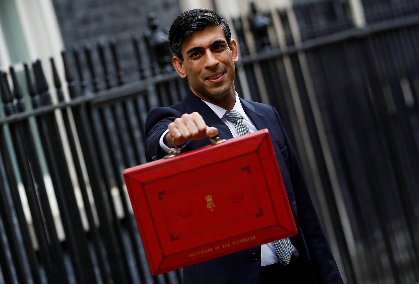 FILE PHOTO: Britain's Chancellor of the Exchequer Rishi Sunak holds the budget box outside his office in Downing Street in London, Britain March 11, 2020. REUTERS/Peter Nicholls/File Photo