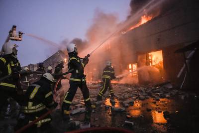 Ukrainian firefighters try to extinguish a blaze at a warehouse after a bombing in Kyiv.  AP Photo