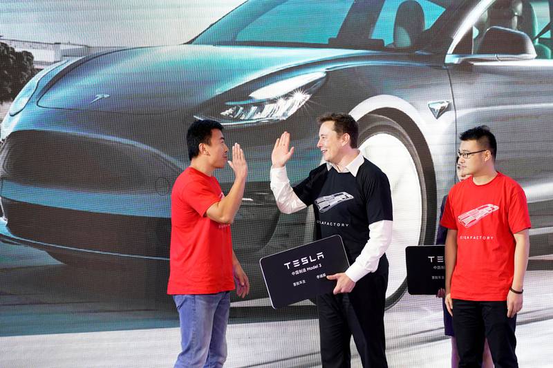 Tesla chief executive Elon Musk with China-made Model 3 vehicle owners during a delivery event in Shanghai in January. Reuters