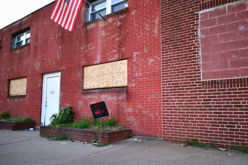 Shuttered buildings with a sign "OUT NOW" and a US flag are seen directly across from Four Seasons Landscaping, the location of a press conference with President Donald Trump's legal team in Philadelphia, Pennsylvania. Reuters