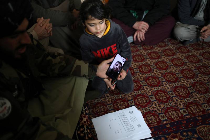 A Taliban member speaks to baby Sohail Ahmadi's father by video at the house of taxi driver Hamid Safi. Reuters