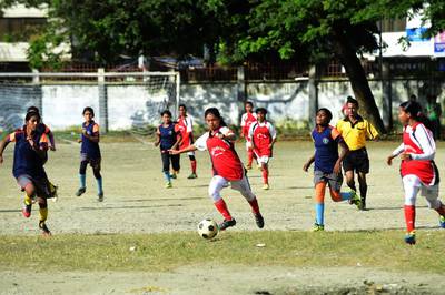 Bangladesh's Kolsindur high school football team captain Maria Manda, centre, controls the ball during a match in Dhaka.  More than a dozen of Kolsindur's players have already played on the national girls' team. Munir uz Zaman/AFP Photo

