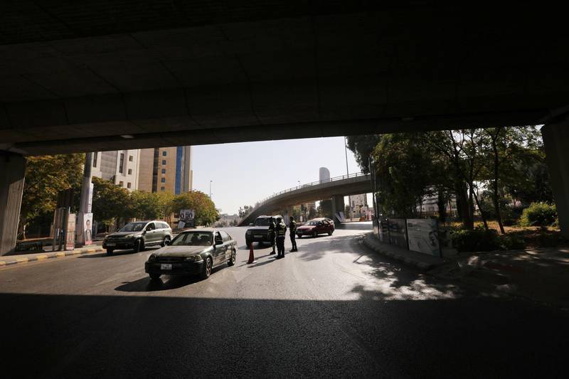 Jordanian police personnel guard at a checkpoint during the second day of a nationwide curfew, imposed for two days, amid fears of a rising number of coronavirus disease (COVID-19) cases in downtown Amman, Jordan. REUTERS
