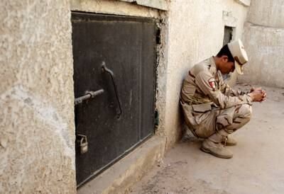 A soldier sits beside a tomb during the funeral of an Egyptian officer who was killed in the May 7 attack. Reuters