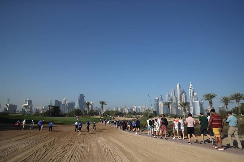 Fans walk on the 13th hole. Getty Images