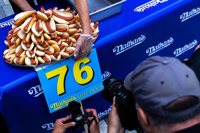 The world record, set by Mr Chestnut last year, is 76 hot dogs and buns in 10 minutes. AP