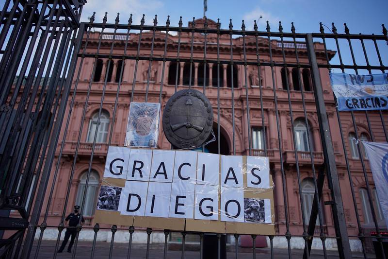 A sign reaing "Thank You Diego' hangs at the gate of the presidential palace in Buenos Aires. AP
