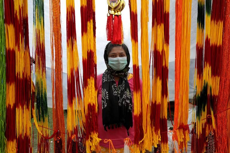 An Indian woman sells holy ropes at Sagar Island during annual fair. EPA