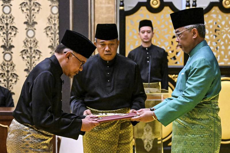 Malaysia's King Sultan Abdullah Sultan Ahmad Shah, right, and newly appointed Prime Minister Anwar Ibrahim, left, take part in the swearing-in ceremony at the National Palace in Kuala Lumpur, Malaysia. AP