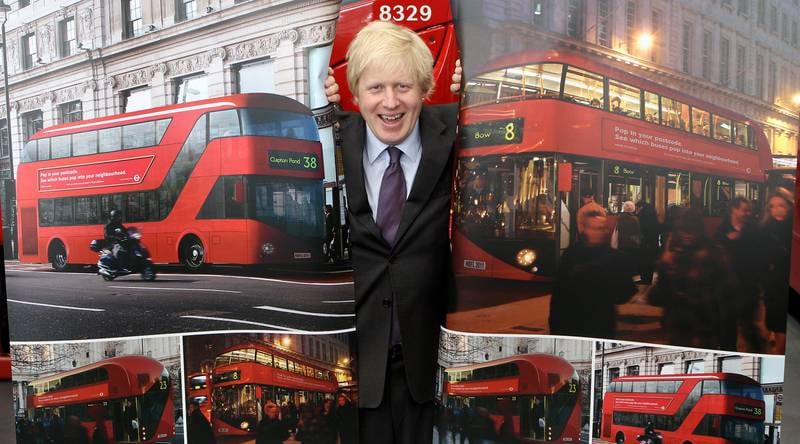 Mr Johnson with artists' impressions of the design for London's new Routemaster bus in May 2010. Getty