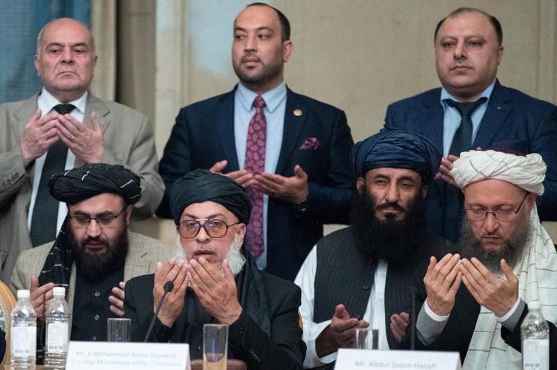 Taliban political chief Sher Mohammad Abbas Stanikzai, first row second from left, Abdul Salam Hanafi and other Taliban official pray during the "intra-Afghan" talks in Moscow, Russia, Wednesday, Feb. 6, 2019. The U.S. has promised to withdraw half of its troops from Afghanistan by the end of April, a Taliban official said Wednesday, but the U.S. military said it has received no orders to begin packing up. (AP Photo/Pavel Golovkin)
