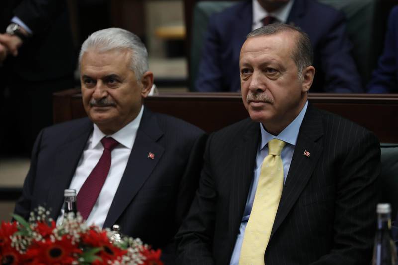 Turkish President and Chairman of the Justice and Development Party (AK Party) Recep Tayyip Erdogan (R) and Turkish Prime Minister Binali Yildirim (L) attend the AK Party's group meeting at the Grand National Assembly of Turkey (TBMM) in Ankara, on October 3, 2017.
Turkish police on October 3, 2017, arrested 35 local authority officials in Istanbul over alleged ties to last year's failed coup, just weeks after the city's long-serving mayor stepped down, state media reported. / AFP PHOTO / ADEM ALTAN