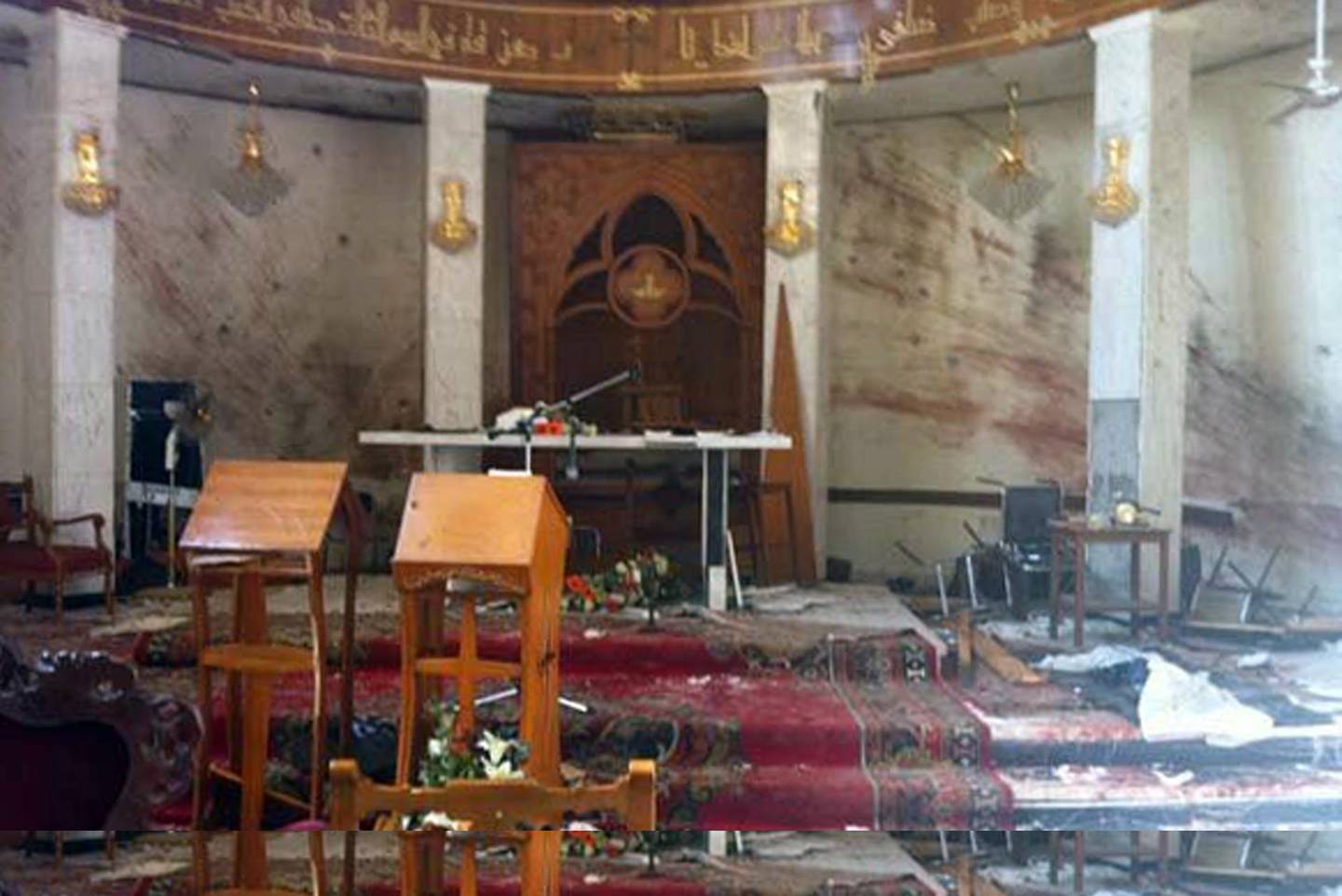 FILE - In this mobile phone camera image obtained by the Associated Press taken Nov. 2, 2010 file photo, the interior of the Our Lady of Salvation church is seen after gunmen took the congregation hostage on Sunday Oct. 31, in Baghdad, Iraq. Iraq has arrested at least 12 suspected al-Qaida insurgents believed to be behind a deadly Baghdad church siege a month ago, the country's interior minister told The Associated Press on Saturday Nov. 27, 2010. The siege ended with 68 people dead. (AP Photo, File)