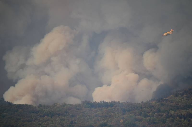 Croatia’s Canadair airplane helps to extinguish wildfires close to the village of Kostanjevica na Krasu.  AFP