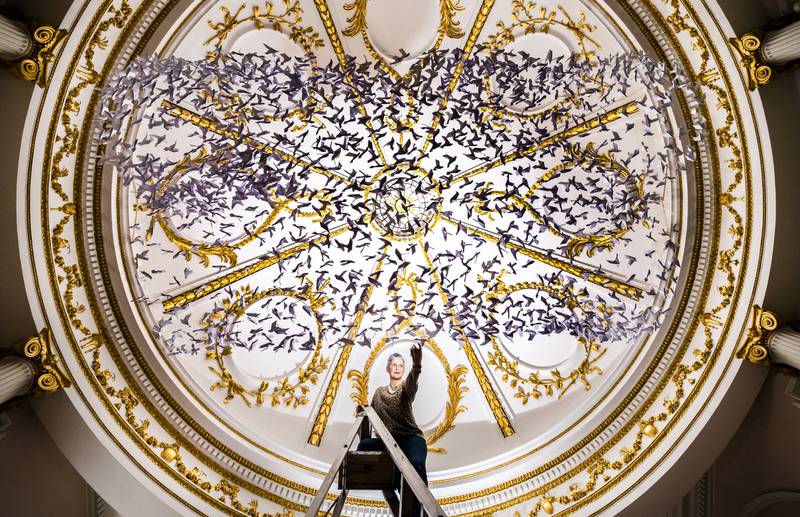 On Monday artist Ails McGee put the finishing touches to Peace on Earth, an art installation made of hundreds of origami doves, on display below the ornate roof of the 18th-century chapel in the Bar Convent in York. PA