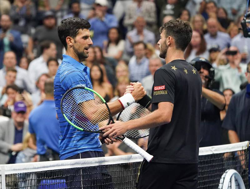 Novak Djokovic of Serbia and Juan Ignacio Londero of Argentina meet at the net and shake hands after Djokovic won their match 6-4, 7-6, 6-1 to advance to the third round of the US Open. AFP