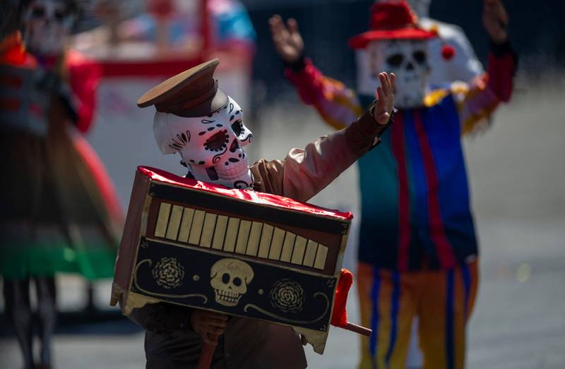 People attend the Day of the Dead parade at Zocalo Square in Mexico City. AFP