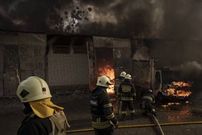 Firefighters battle flames at a warehouse after a Russian bombardment in Kharkiv, Ukraine. AP Photo