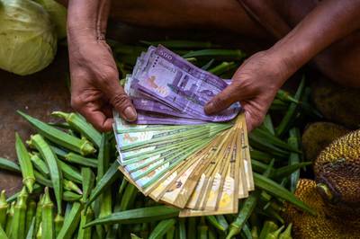 Sri Lankan banknotes at a market in Colombo. The IMF expects the country's inflation to come down to 28.5 per cent this year. AFP