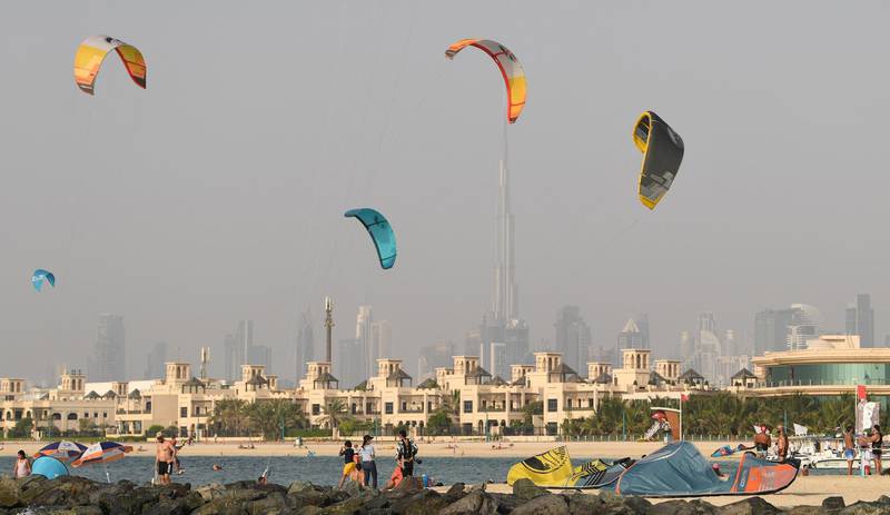 People kite-surf during the Dubai watersport festival, organised by the Dubai International Marine Club (DIMC), in the Gulf emirate on June 26, 2020.  / AFP / KARIM SAHIB
