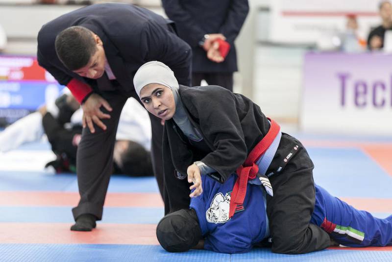 Maitha Harasi, black, fights Shamsa Hasan, during a Female Blue Adult 55KG match at Al Ain Jiu Jitsu Open Championship. Reem Mohammed / The National