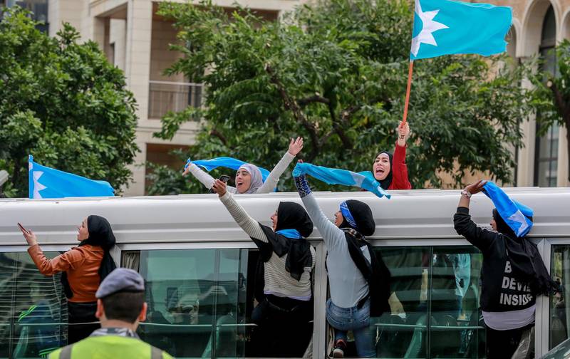 Supporters of Lebanon's al-Mustaqbal ('Future') movement wave their flags while riding on a bus as they arrive to attend the 15th anniversary commemoration of the assassination of former Lebanese Prime Minister Rafic Hariri in Beirut, Lebanon.  EPA