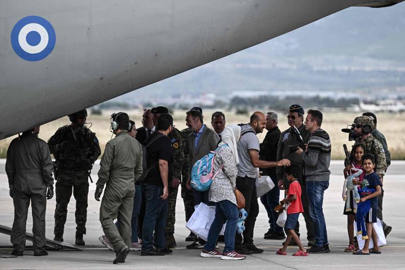 Greek citizens arrive from Sudan on a military plane in Elefsina, south of Athens. AFP